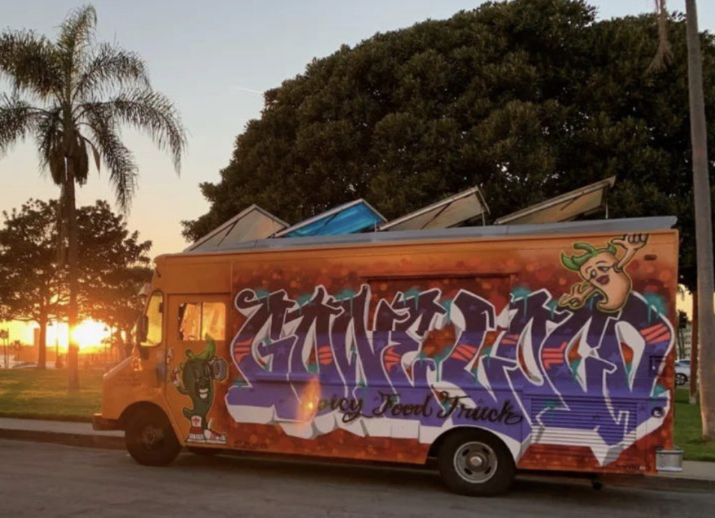 Artist showing the food truck they painted.